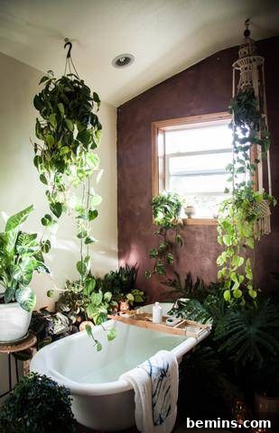 17 Stunning Bathrooms That Embrace the Shower Plant Trend 13 A claw bathtub in a bathroom full of live plants.