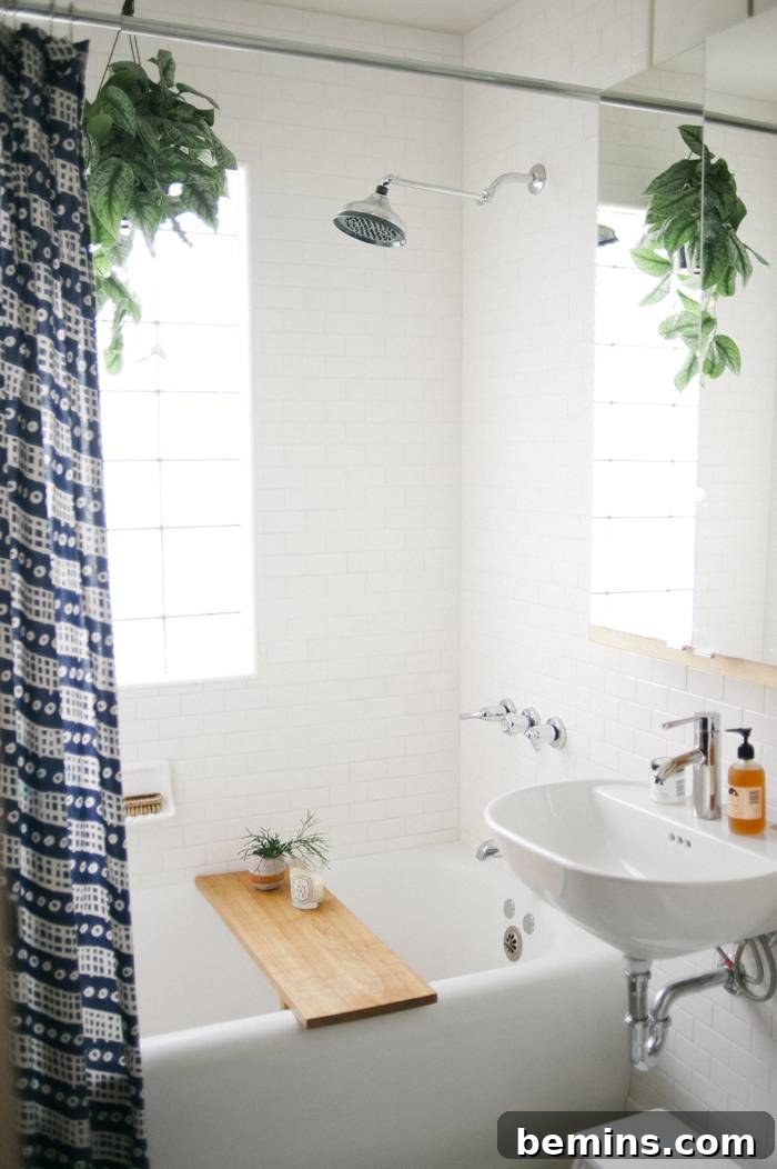 17 Stunning Bathrooms That Embrace the Shower Plant Trend 14 A tub with a board over it with a window that has the sun shining