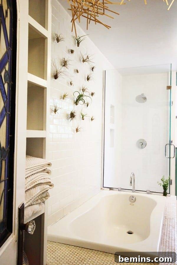17 Stunning Bathrooms That Embrace the Shower Plant Trend 8 This modern bathroom has a large soaking tub and a shower behind it with a glass door.