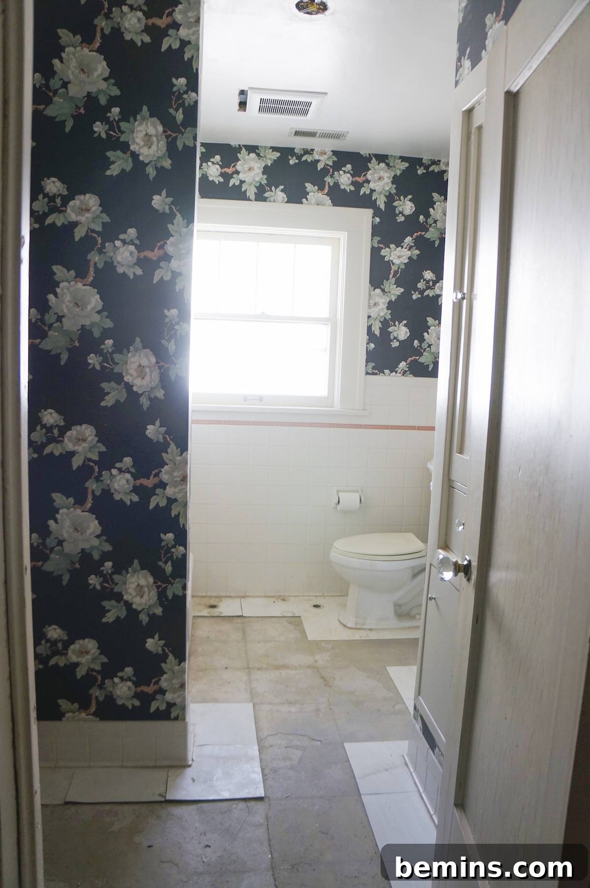 The bathroom after an initial cleanup, showing removed radiators and holes from electrical work.