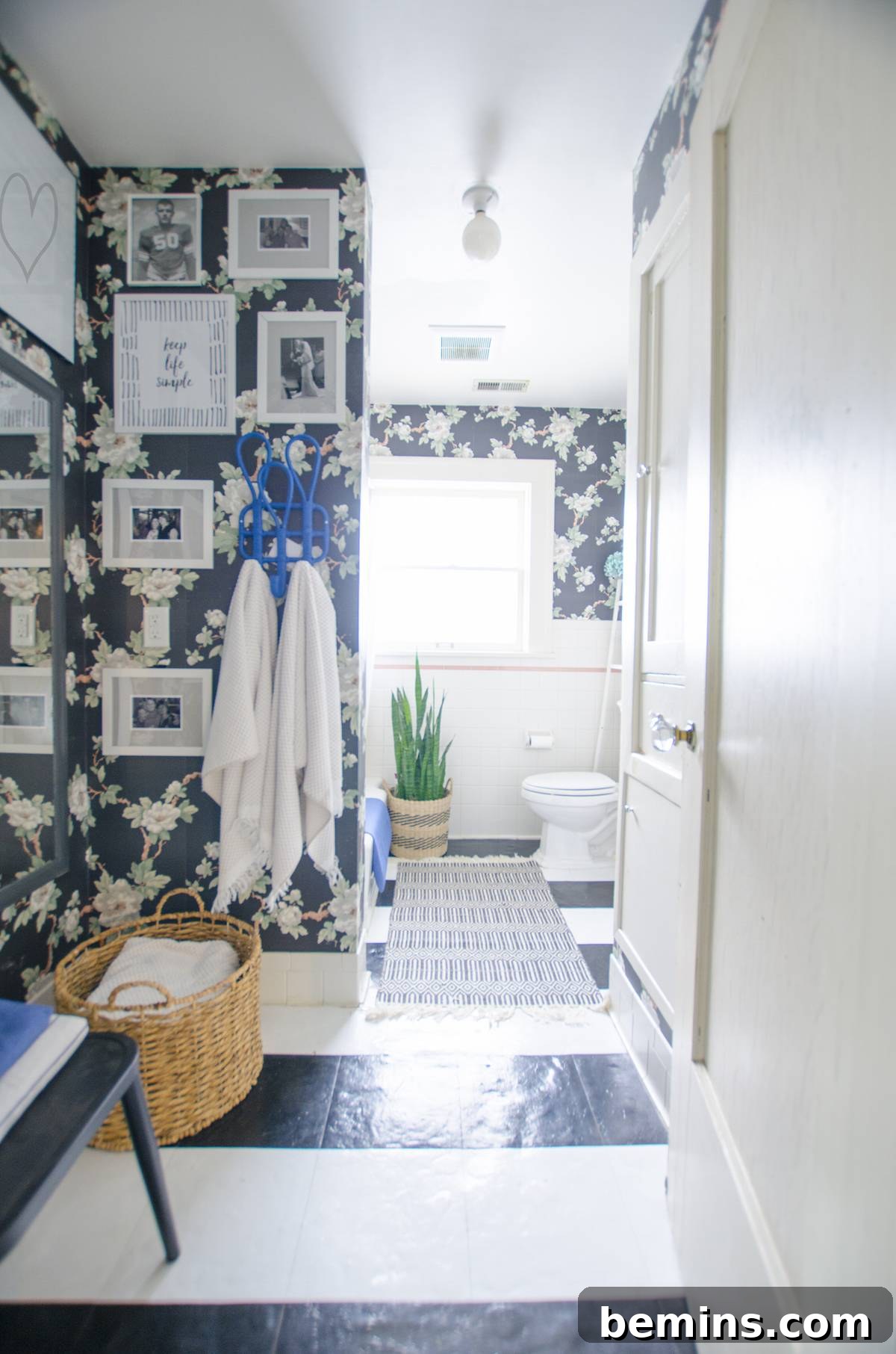 The bathroom after the refresh, showcasing the striped floor, gallery wall, and added accessories.