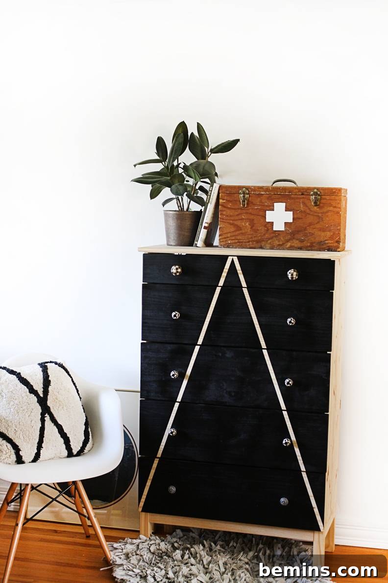15 Genius IKEA Bedroom Hacks for a Seasonal Home Update 14 Black wooden drawer set pressed up against a wall with a plant wooden basket sitting on top of it.