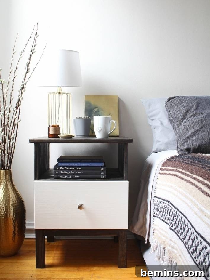 15 Genius IKEA Bedroom Hacks for a Seasonal Home Update 4 Items sit on a bedside table near a table with striped sheets.