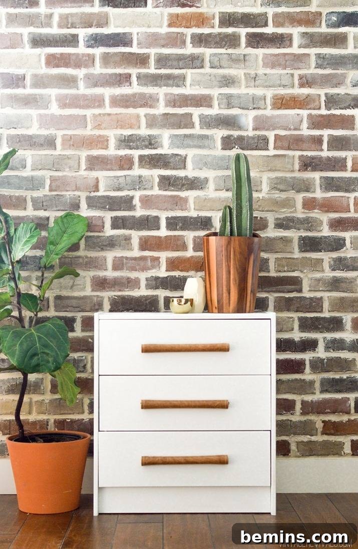 15 Genius IKEA Bedroom Hacks for a Seasonal Home Update 5 A white sideboard has a vase and is sitting in front of a brick wall.