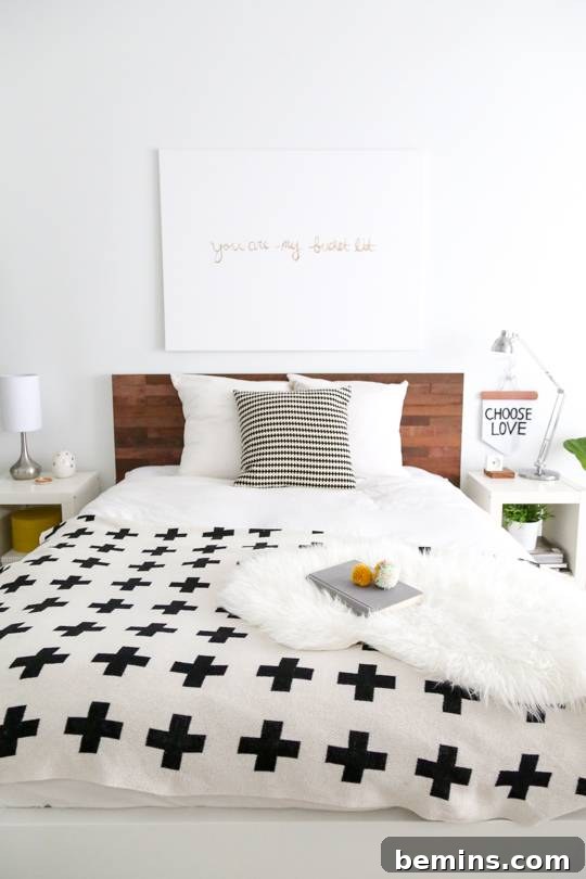 15 Genius IKEA Bedroom Hacks for a Seasonal Home Update 7 A white bedroom has a large, white bed with black crosses on it.