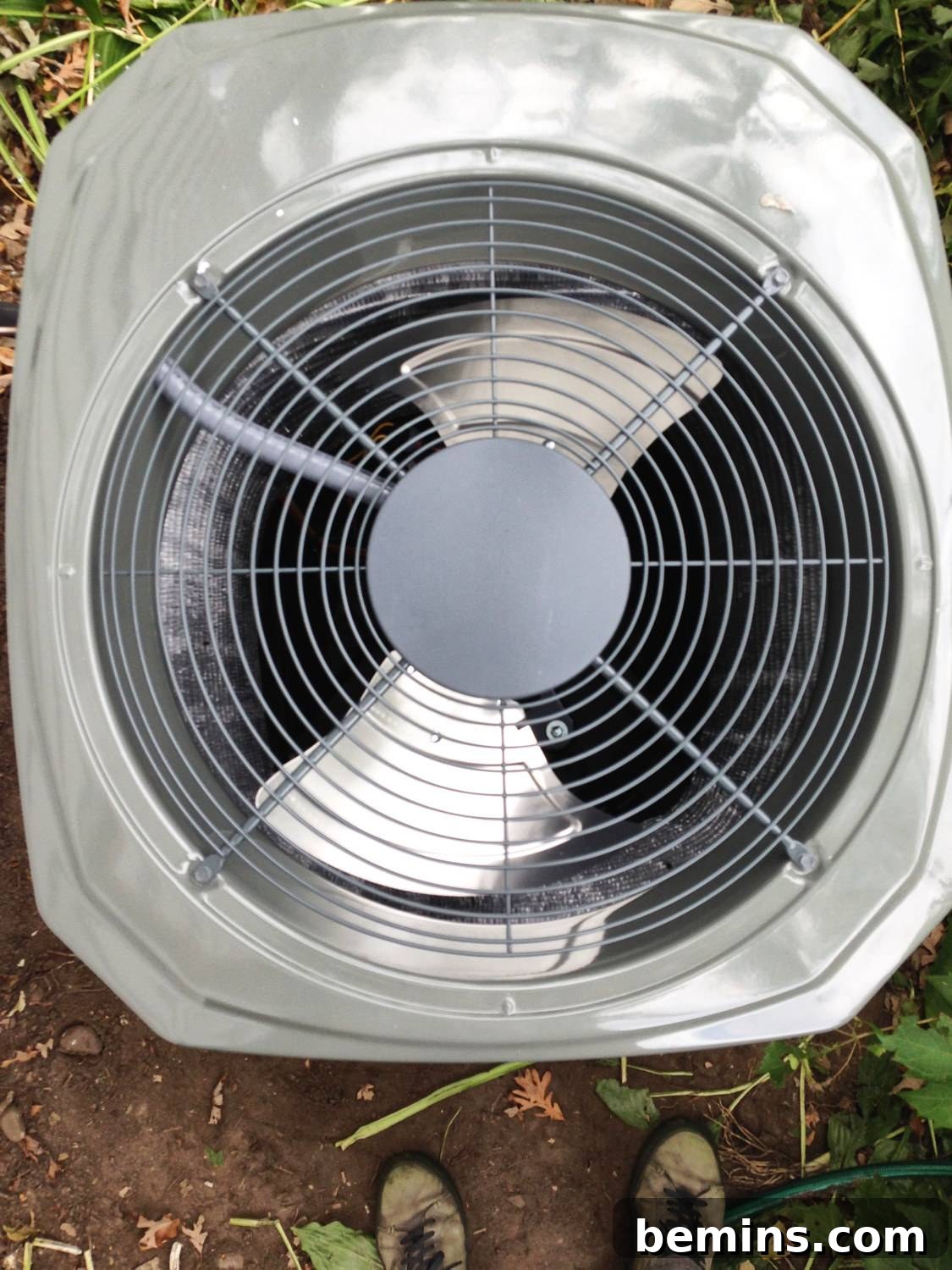 A silver outdoor air conditioning unit that is currently not operating.