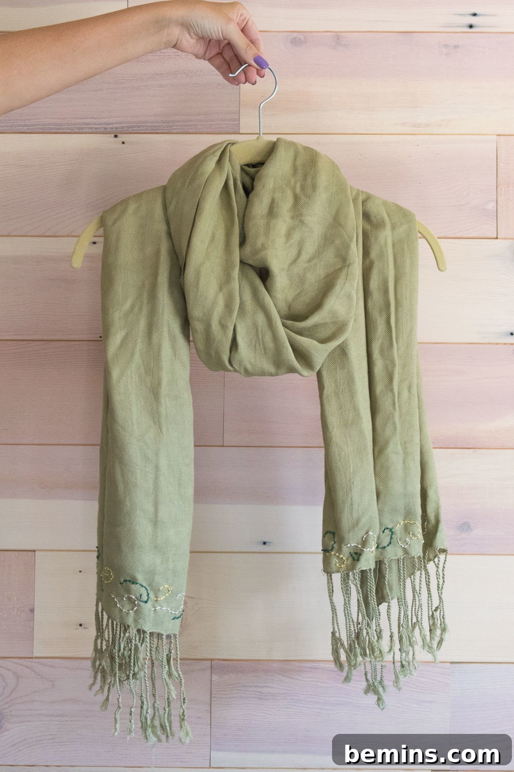 Elegant green scarf on a hanger, ready for fall fashion