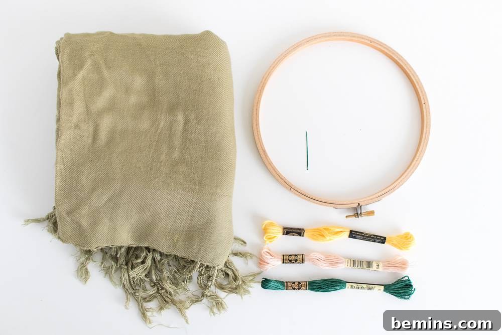 Essential embroidery tools and soft fabric, ready for a creative project