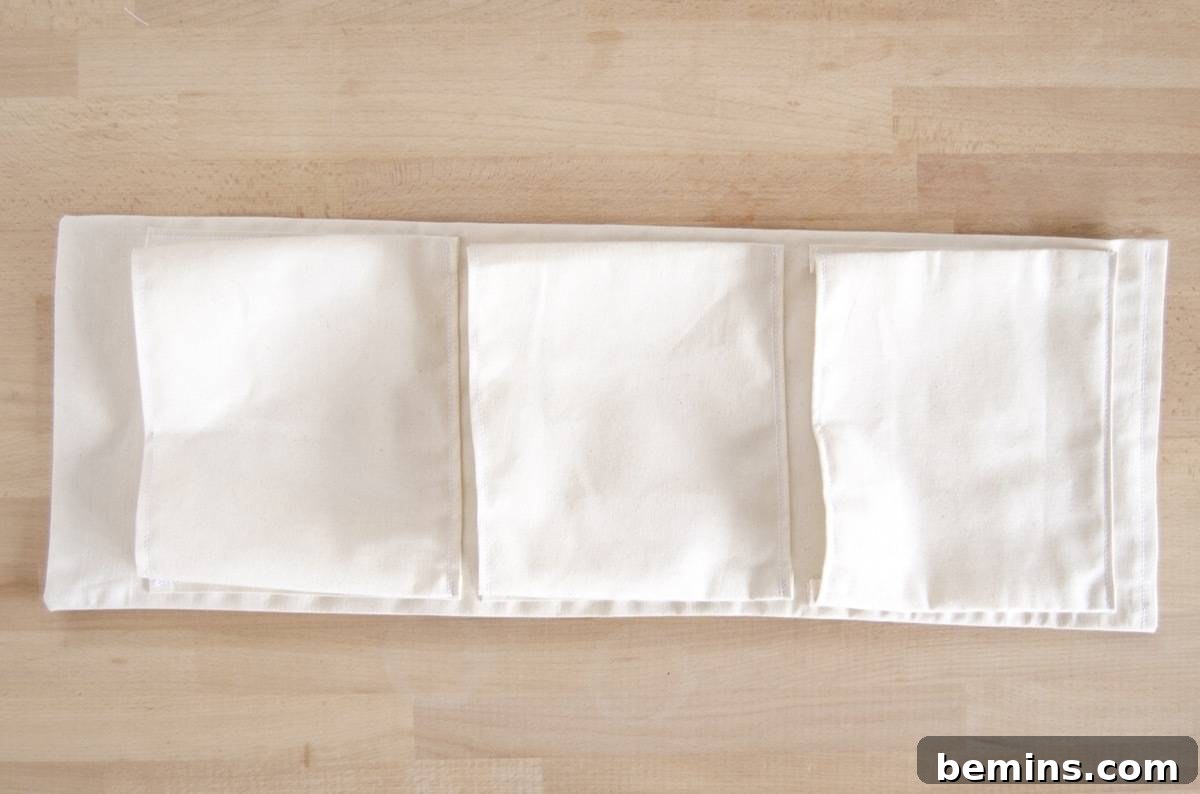 Repeating the pocket attachment process for all three hanging fabric planter pockets