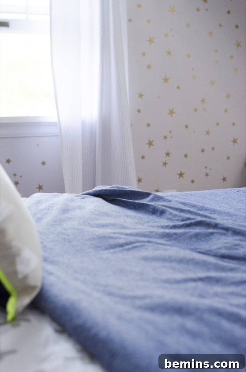 A detail of a styled bedroom with a bed, bedding, and pillows.