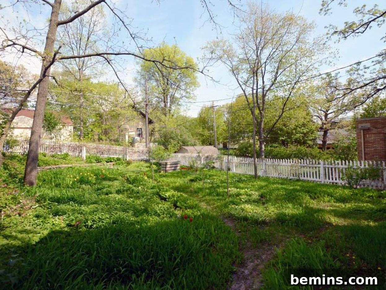 Lush green bushes lining a white fence, enhancing curb appeal.