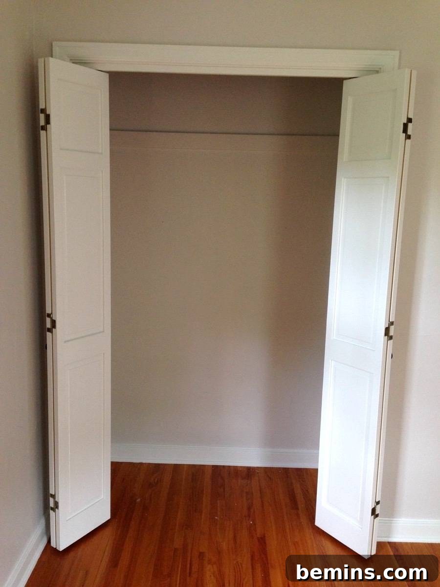 An empty closet with white doors, showcasing the potential for organized storage.