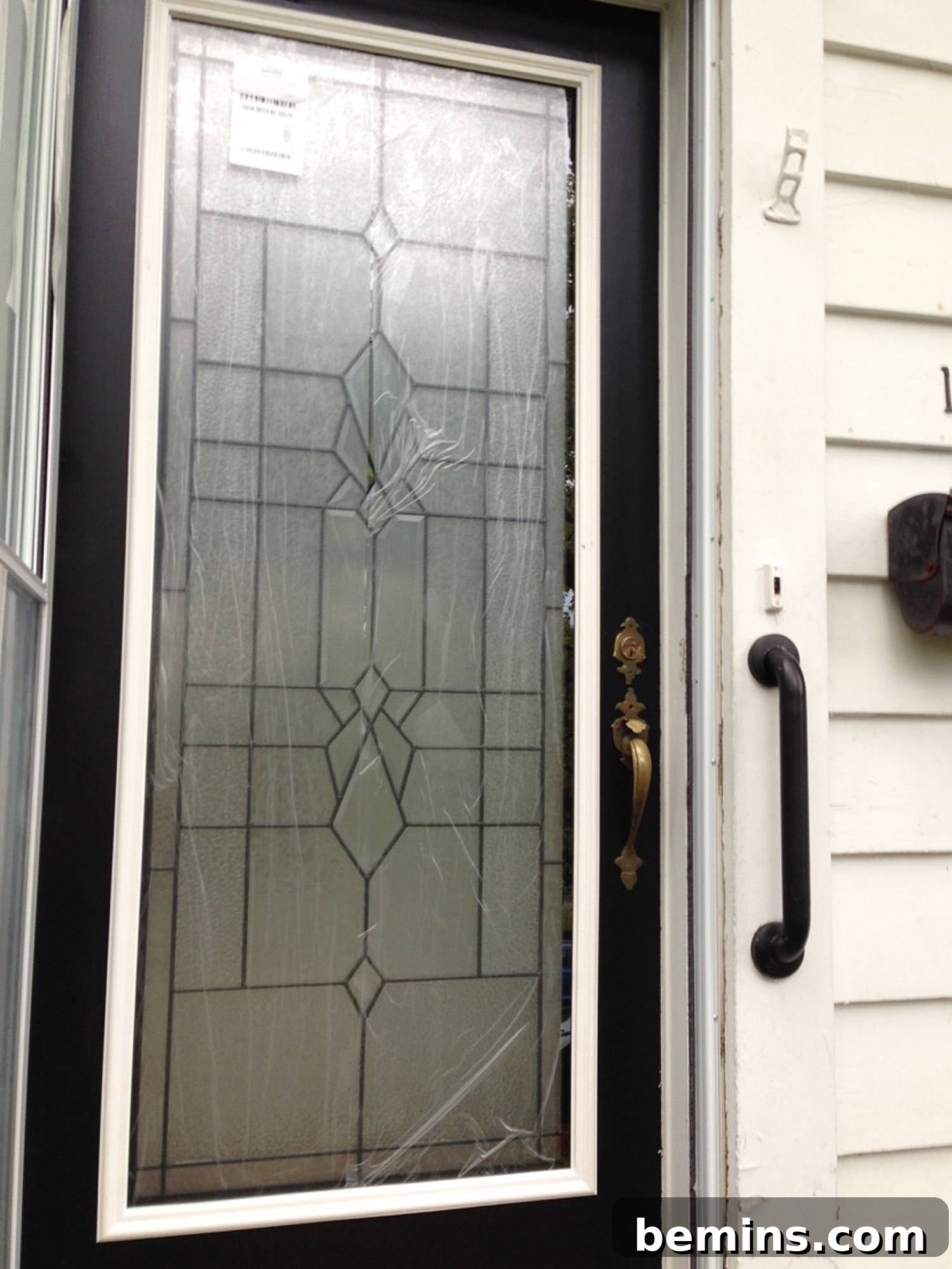 A modern front door with a glass insert, adding natural light and curb appeal.