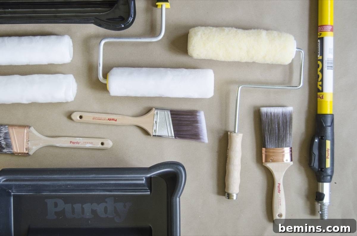 Collection of painting supplies including brushes, rollers, paint tray, and paint cans.
