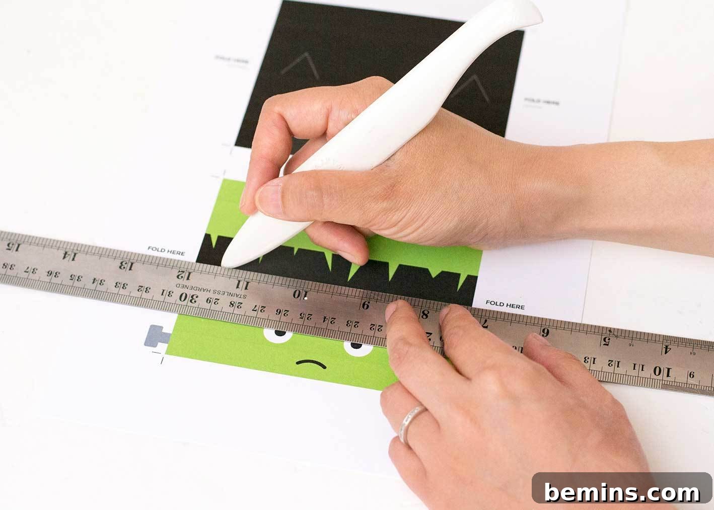 Scoring the Halloween treat bag topper with a ruler and bone folder