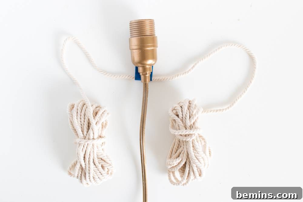 Close-up of the bulb holder, electrical wire, and bundled macrame rope, showcasing the initial steps of the project.