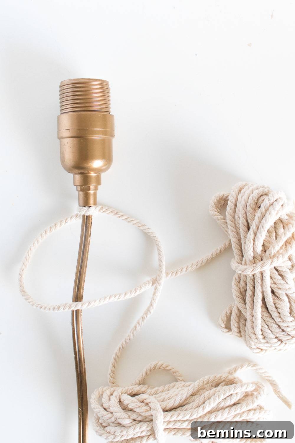 Image showing the macrame rope being aligned with the light cord, ready for the first knot.