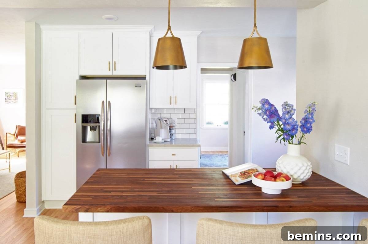 The Curbly House: A 2017 Renovation Reveal 39 Curbly House Kitchen, Over Butcher Block Island, White Cabinets with Gold Hardware