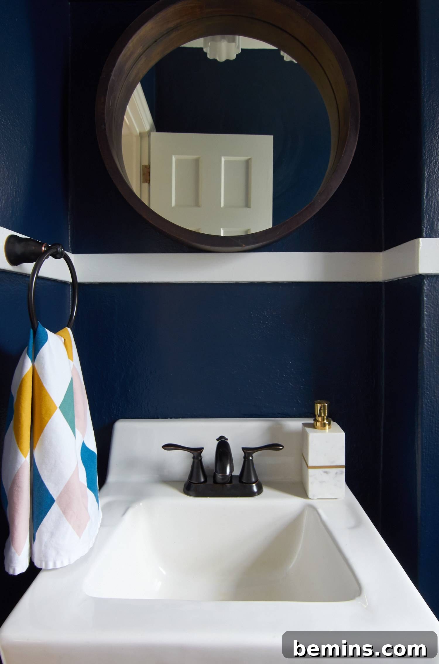 round wood mirror and white trim 