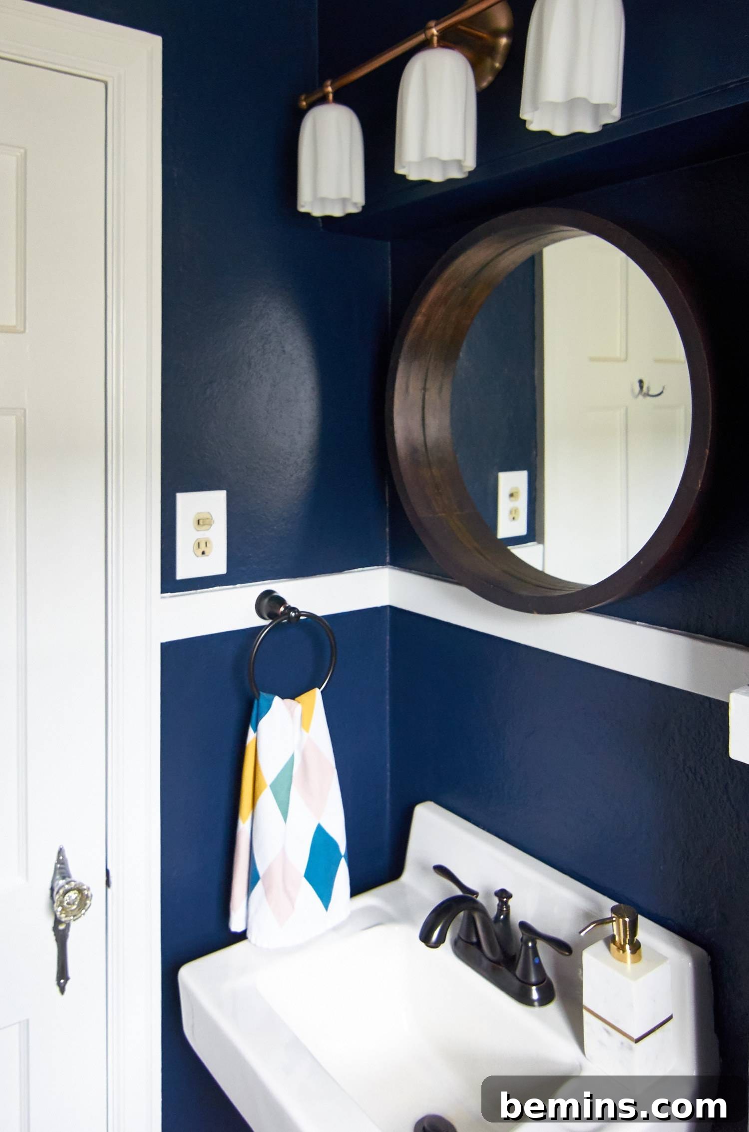 Small bathroom sink with round mirror