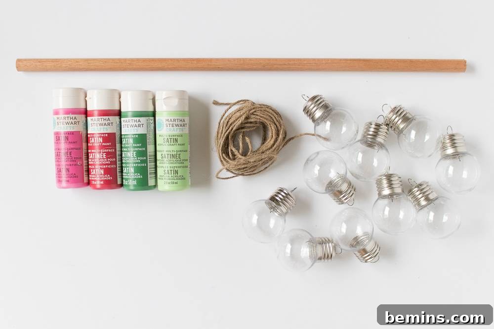 Close-up shot of essential crafting supplies: string lights, natural twine, and colorful paints, all neatly arranged on a clean white surface.