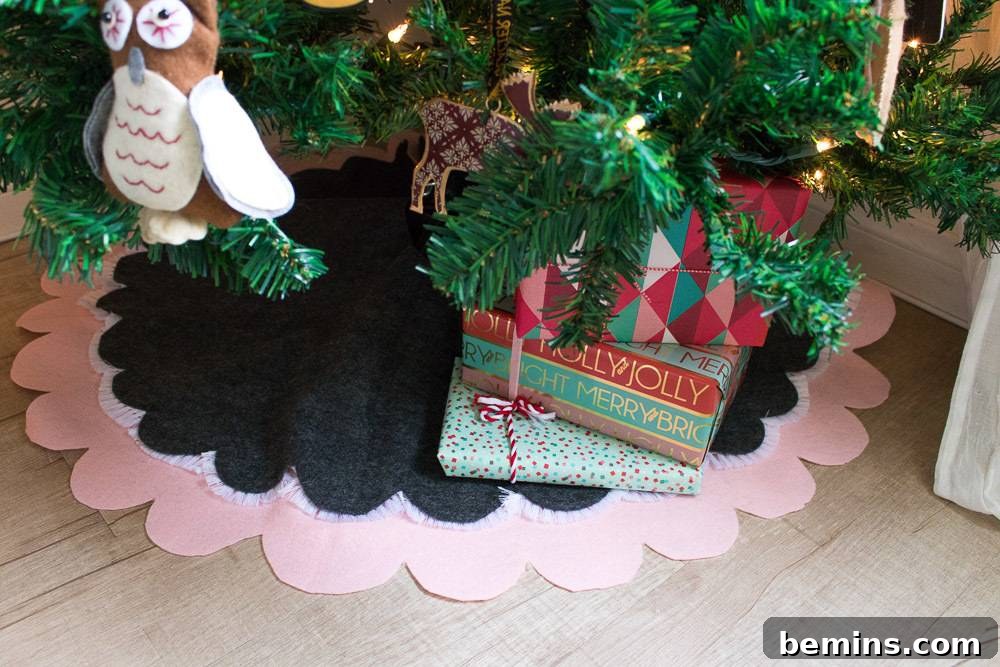 Elegant black and tan scalloped tree skirt complementing a Christmas tree adorned with an owl ornament