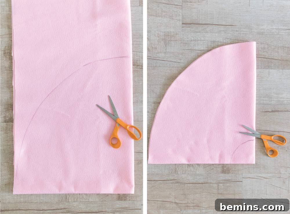 Close-up of orange-handled scissors resting on pink felt, ready for crafting