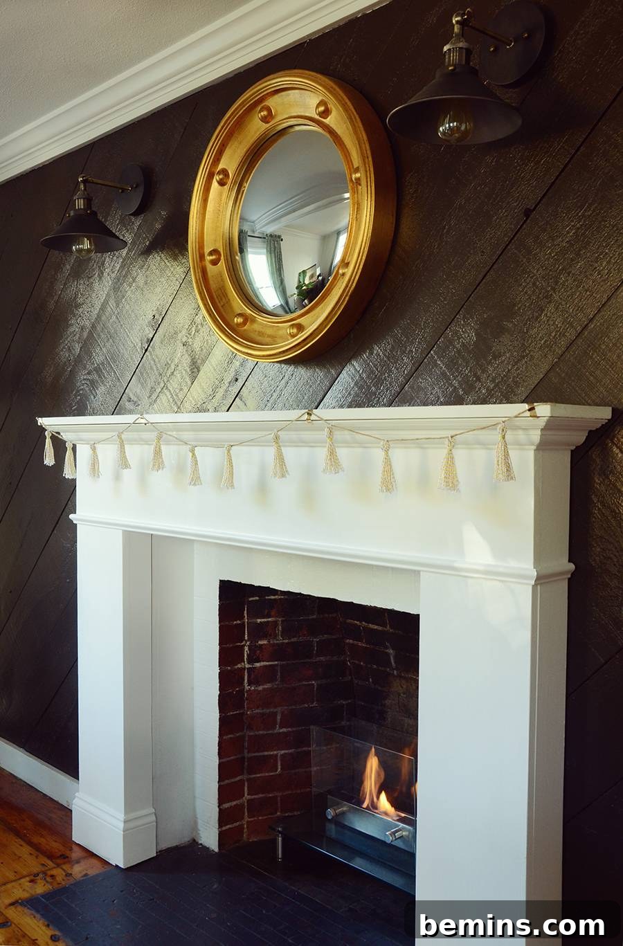 DIY Gold Tassel Garland hanging vertically in a room