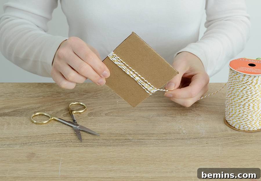 Wrapping baker's twine around cardboard