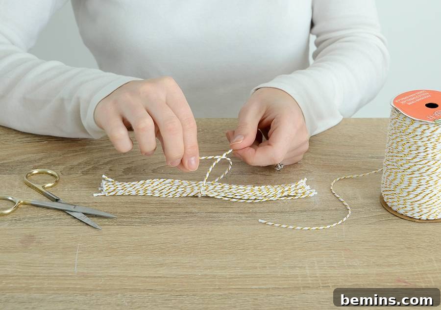 Tying twine around the middle of the tassel strands