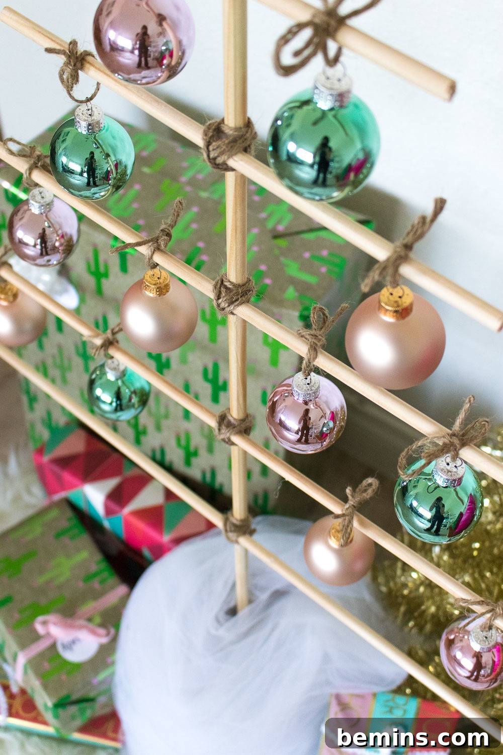 Wooden dowels made to look like a decorated Christmas tree.
