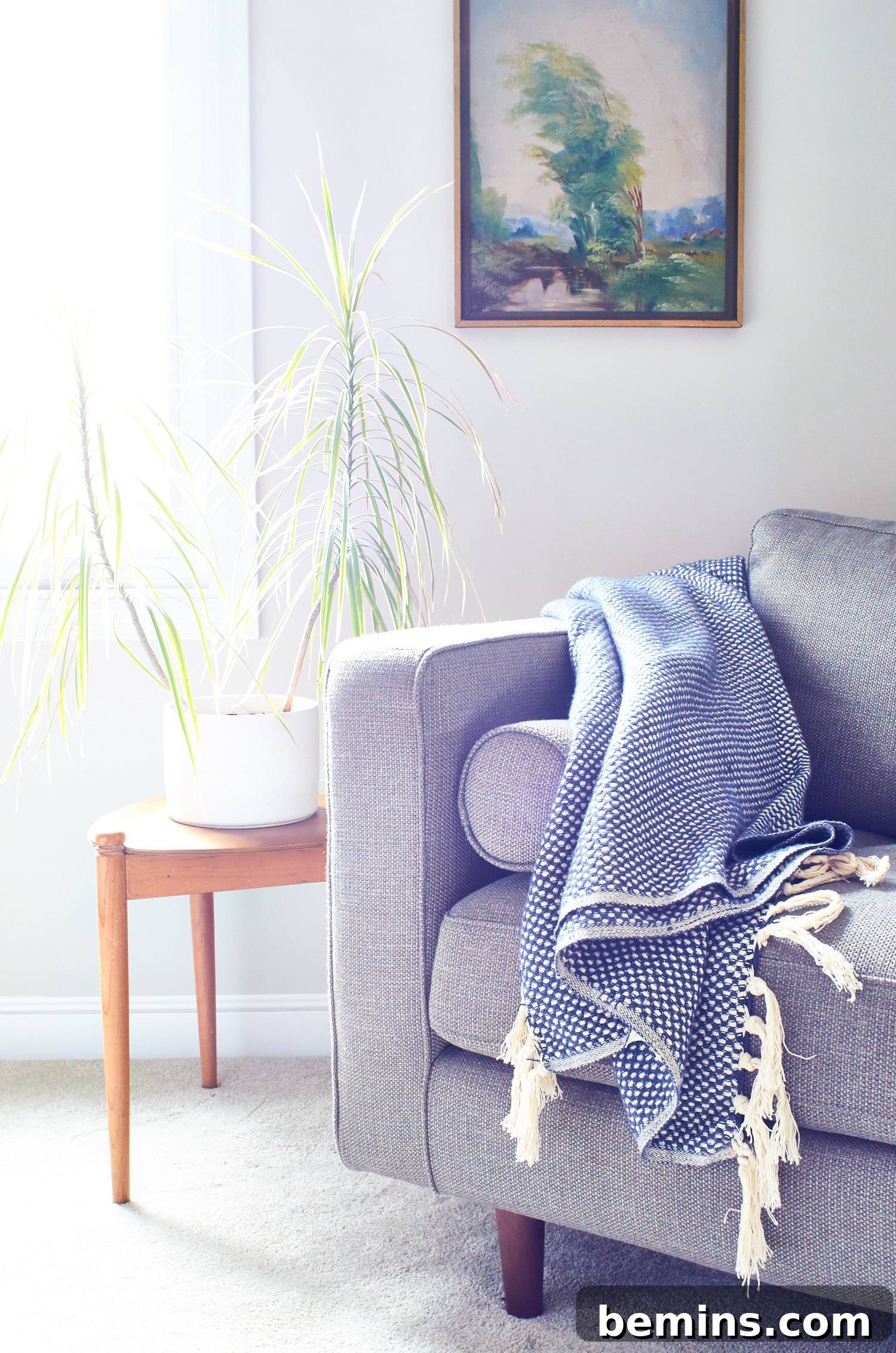 A cozy blanket draped elegantly over the arm of a sofa. Soft textures and thoughtful details contribute to an inviting living space.