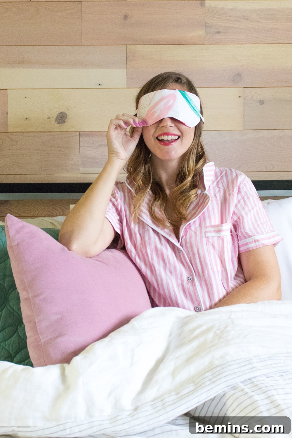 Woman wearing an eye mask in bed, promoting better sleep with a DIY eye mask.
