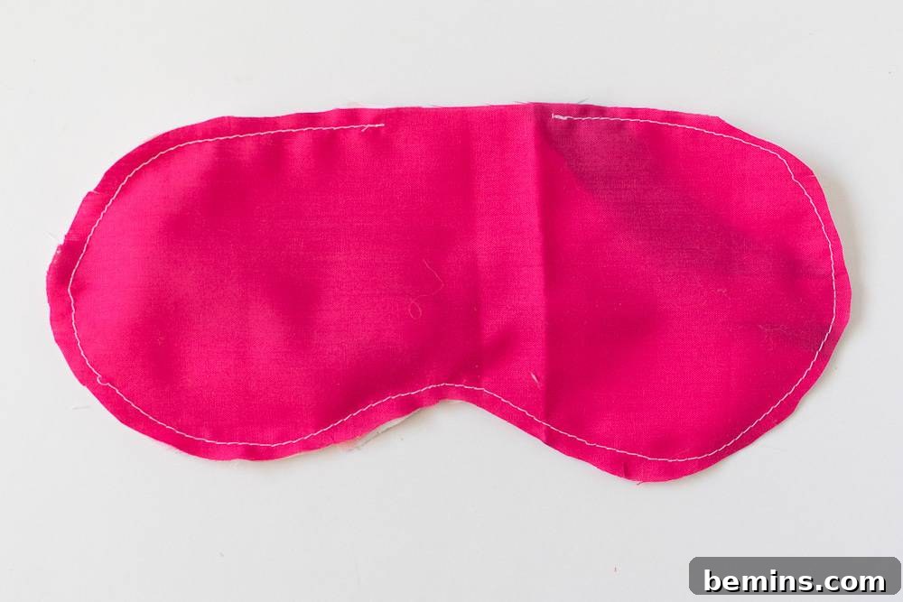 A partially sewn sleep mask being turned right side out.