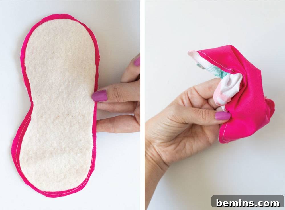 Hand holding a pink eye mask, demonstrating the size and finished appearance of the DIY project.