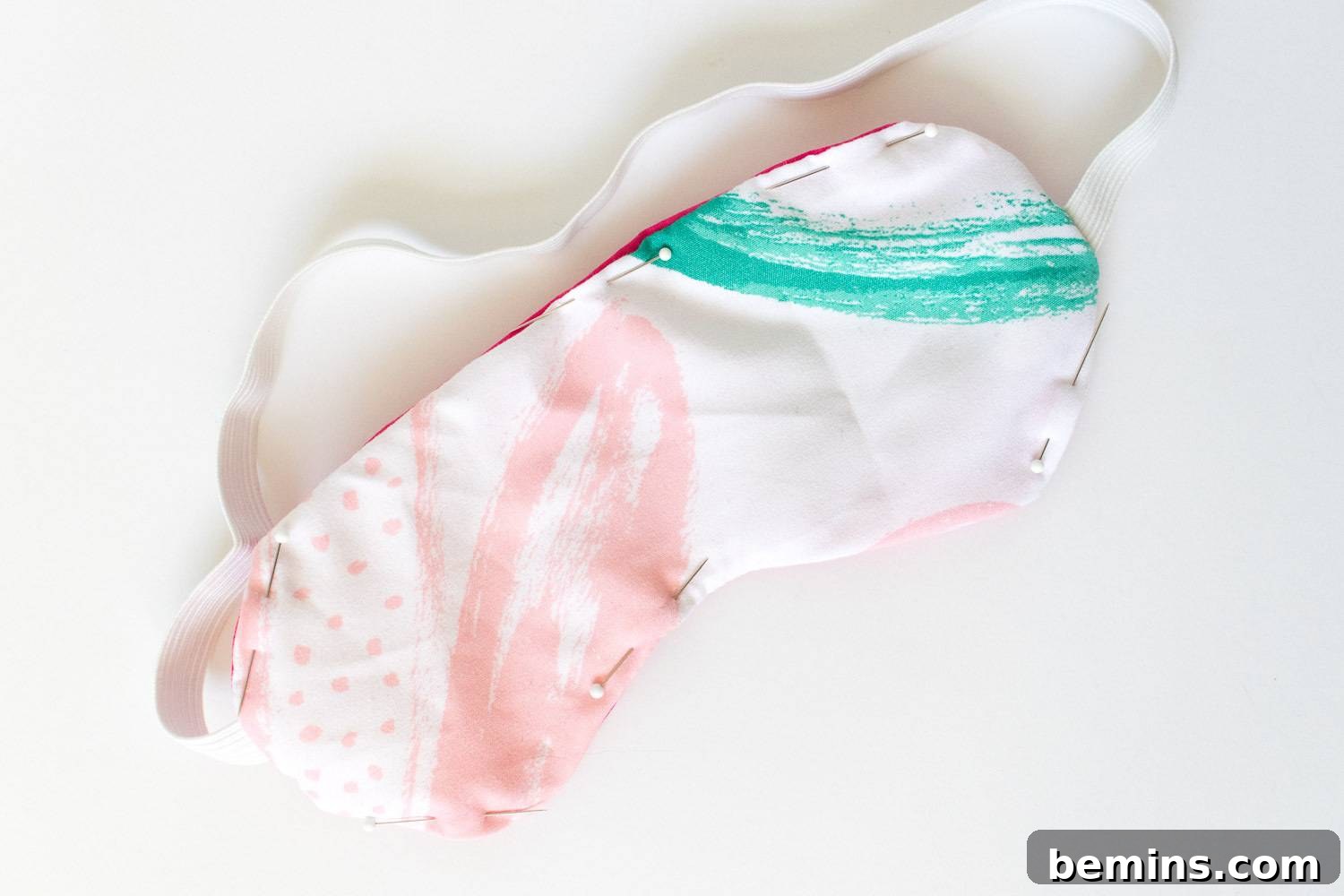 A finished cotton sleep mask with an elastic strap.