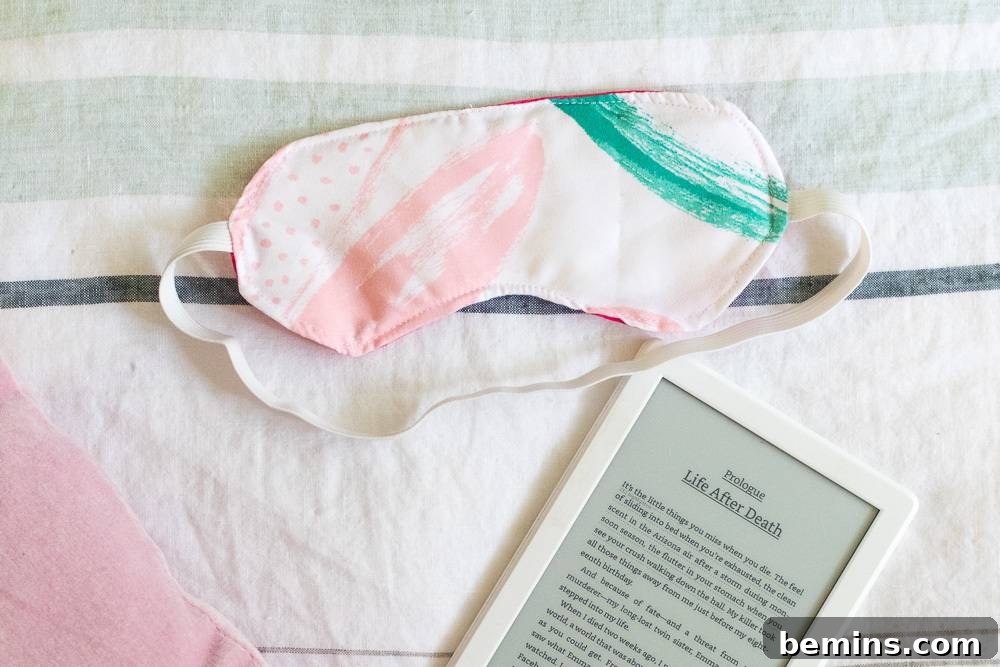Sleep mask near an ereader, suggesting the use of a sleep mask for relaxation and improved sleep quality.
