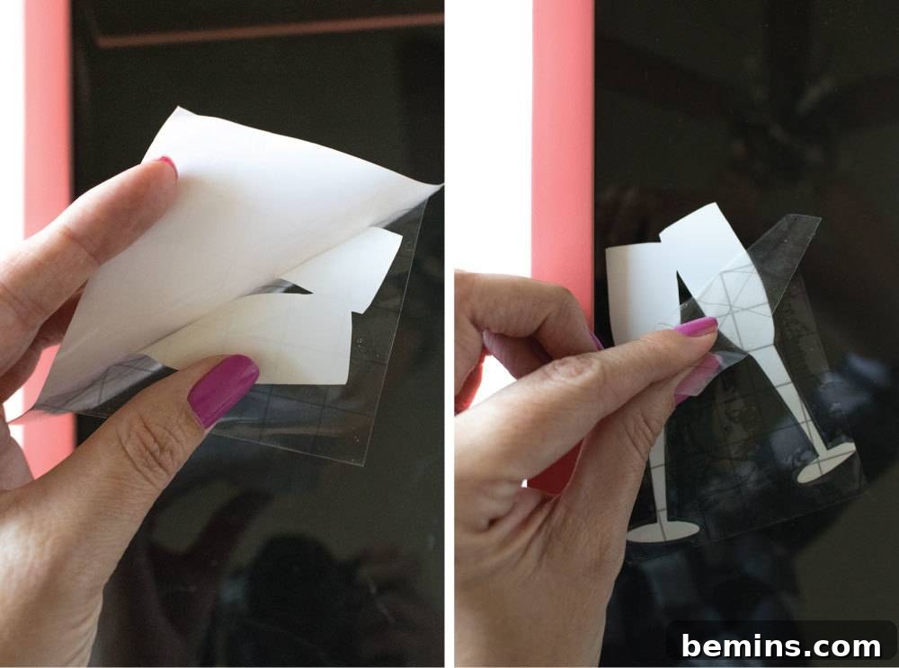 A paper cutout of wine glasses being held up by a hand, ready for the next step.