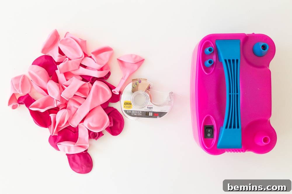 Pink and blue object next to bright pink flowers and tape for balloon display