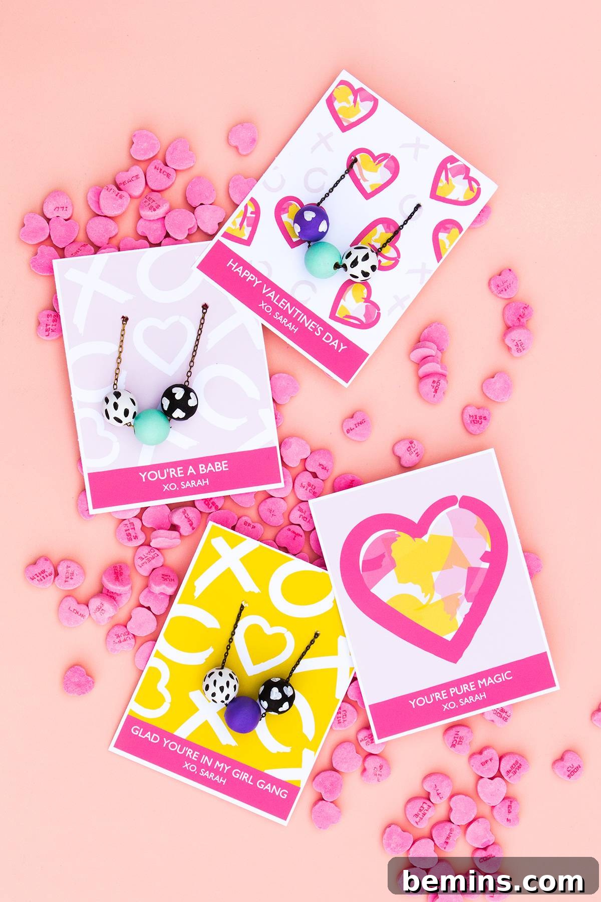 Beyond the Box: 25 Heartfelt Valentines Your Loved One Will Cherish 3 Pink candy hearts scattered around four Valentines greeting cards.