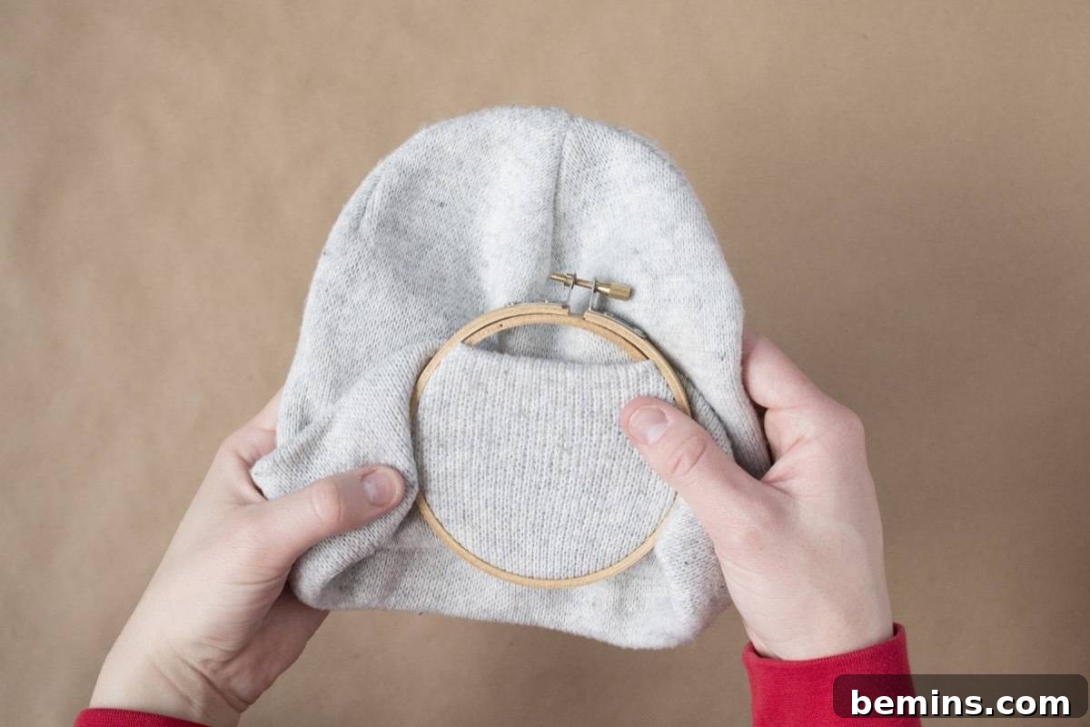 Fixing the embroidery hoop onto the beanie