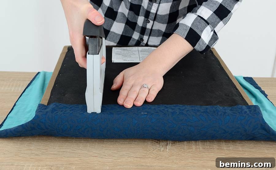 Effortless Ottoman Upgrade: A Simple DIY Transformation 6 Cutting and Stapling Fabric for Ottoman Reupholstering