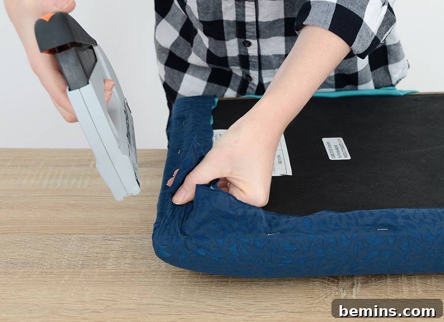 Effortless Ottoman Upgrade: A Simple DIY Transformation 9 Reattaching the Base to the Upholstered Cushion