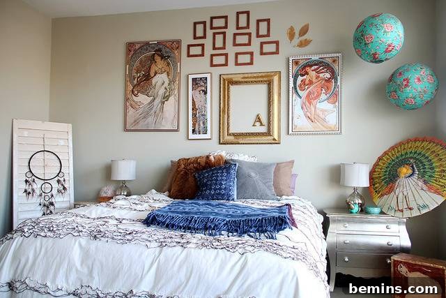 Bohemian bedroom with empty frames and colorful accents.