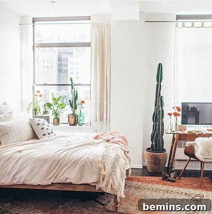 Boho bedroom and workspace with cacti and layered rugs.