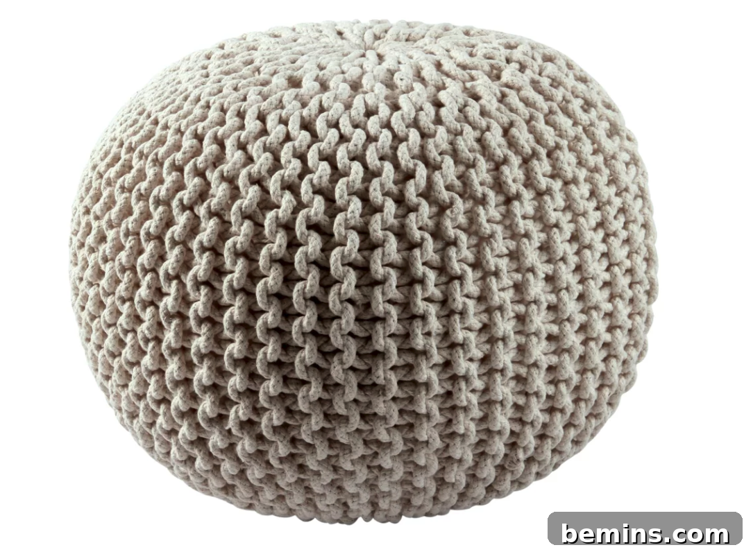 Neutral knitted pouf for an inviting look.