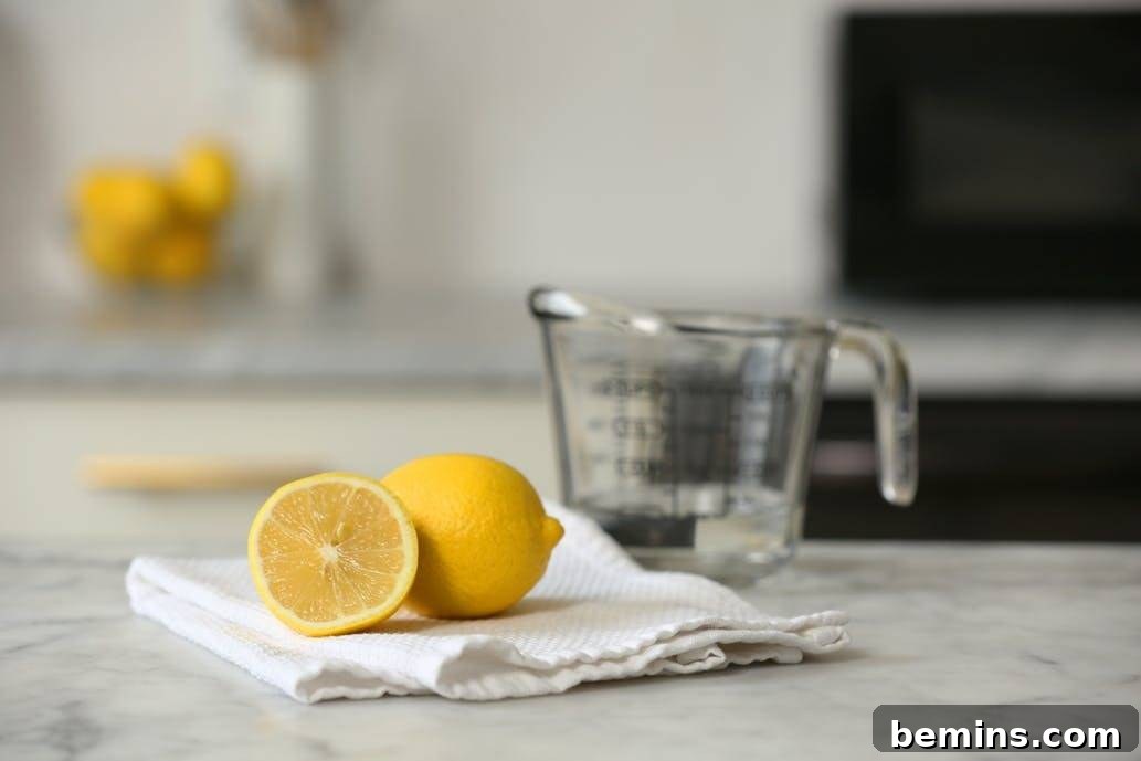 Ultimate Home Cleaning Guide: Room-by-Room Secrets 11 Lemon halves near a glass measuring cup.