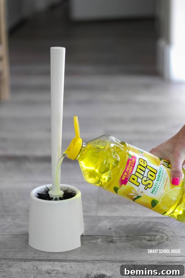 Ultimate Home Cleaning Guide: Room-by-Room Secrets 14 Bottle of Pine Sol near a toilet brush holder.