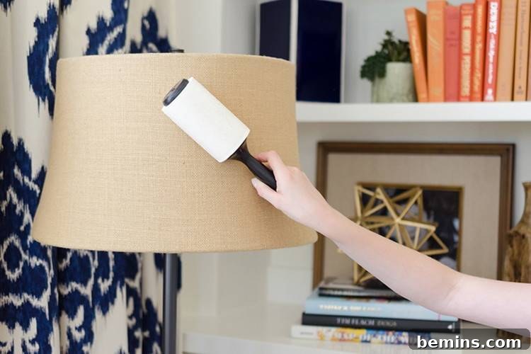 Ultimate Home Cleaning Guide: Room-by-Room Secrets 5 Girl cleaning a lampshade with a lint roller.