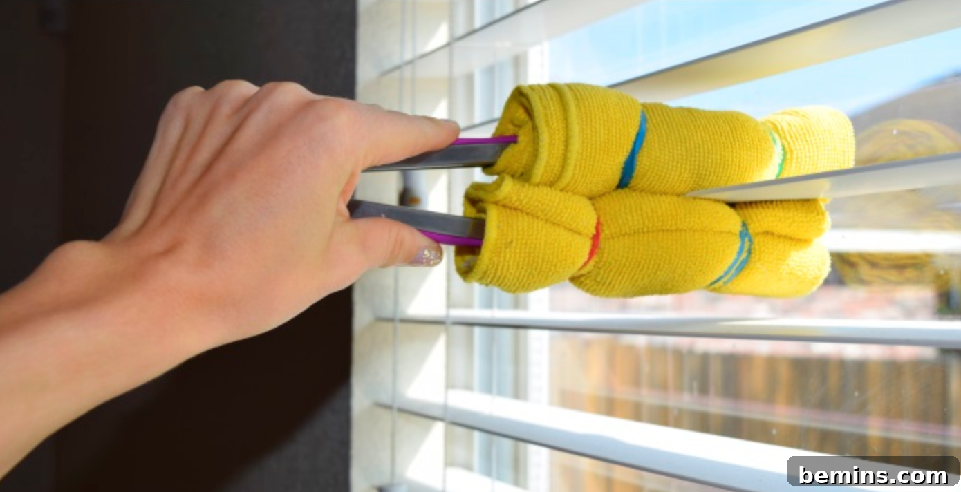 Ultimate Home Cleaning Guide: Room-by-Room Secrets 6 Person cleaning blinds with kitchen tongs and microfiber cloths.
